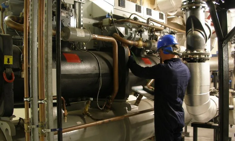 Solutions Plus technician servicing a water-cooled chiller